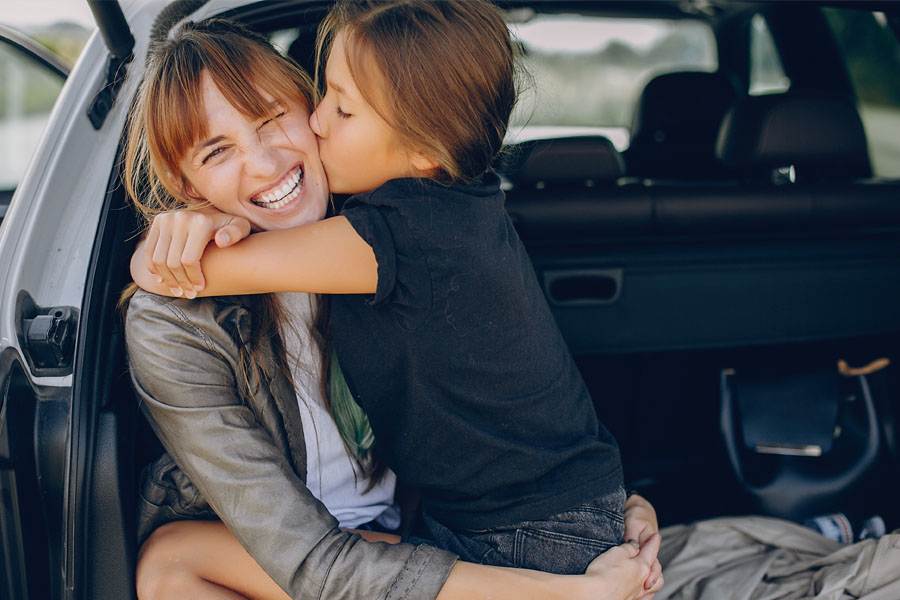 Personal Insurance - Mother and Daughter Hugging in the Car