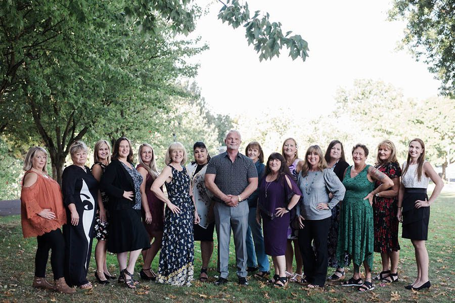 About Our Agency - Strand Insurance Team Standing Together In A Beautiful Park