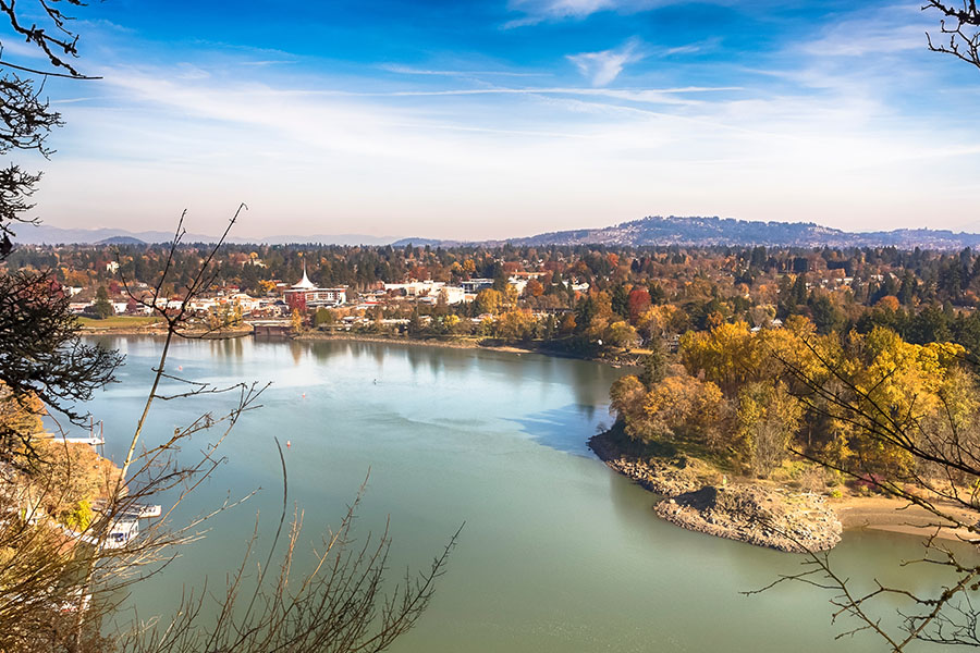 Sahli-Miller Insurance – Milwaukie, OR - Aerial View of Town in Milwaukie, OR with a Lake and Mountains on a Nice Day